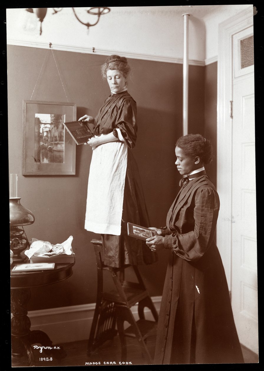 Madge Carr Cook hängt Bilder mit ihrer Magd auf, ca. 1904 von Byron Company