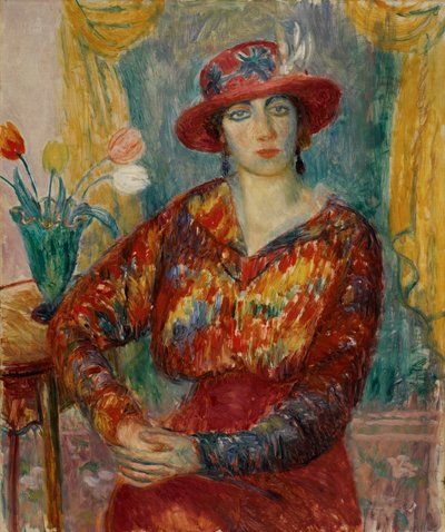 Frau in roter Bluse mit Tulpen von William James Glackens